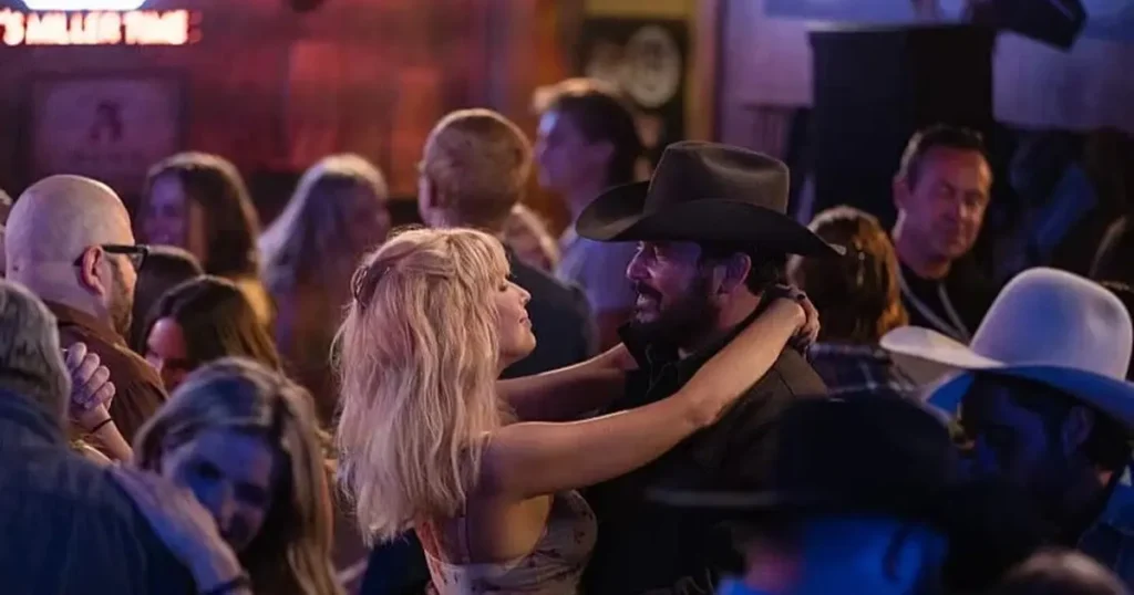Kelly Reilly as Beth Dutton dancing with Rip Wheeler in a crowded bar on Yellowstone