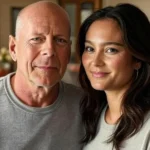 Bruce Willis sitting with Emma Heming Willis and their daughters in a sunlit living room, sharing a quiet, supportive family moment