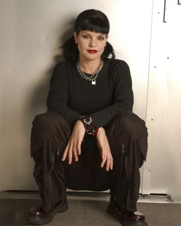 Pauley Perrette as Abby Sciuto wearing her signature black outfit and chunky jewelry on NCIS