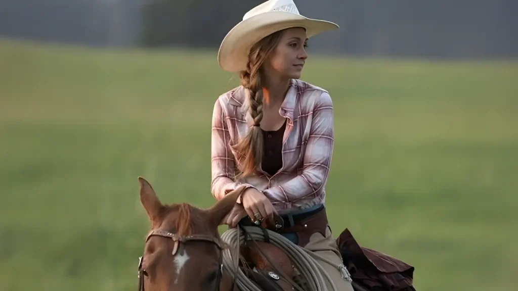 Amber Marshall with her horse at sunset near the Heartland ranch