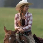 Amber Marshall with her horse at sunset near the Heartland ranch