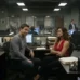 NCIS bullpen with Tony and Ziva trading a wary look across their desks, early days before the romance.