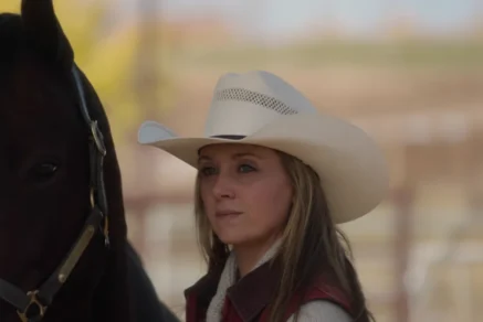 Amy Fleming standing beside a horse at Heartland ranch, calm and focused expression