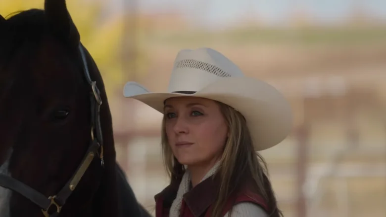Amy Fleming standing beside a horse at Heartland ranch, calm and focused expression